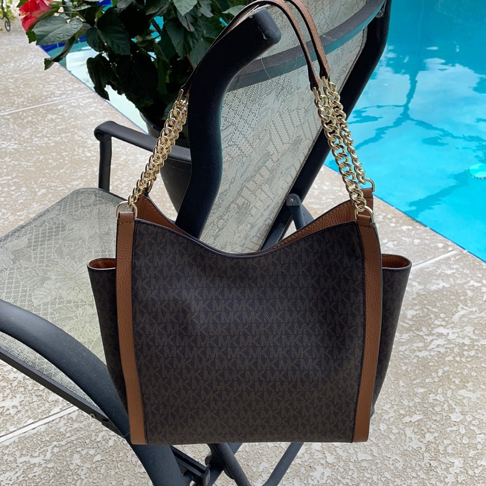 Michael Kors handbag with lots of dividers, slip pockets and 2 zip pockets.